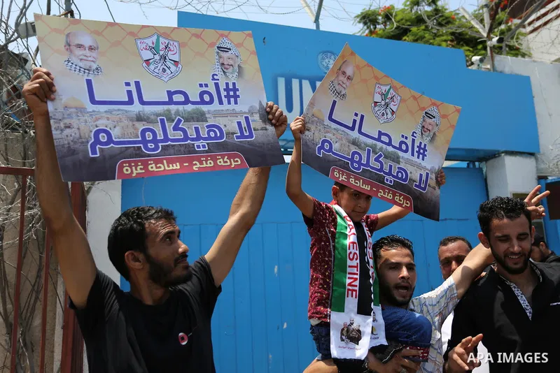 Palestinians Supporters of Fateh movement hold banners and march during a demonstration in Gaza City on July 20, 2017 against new Israeli security measures at Al-Aqsa mosque compound, which include metal detectors and ca...