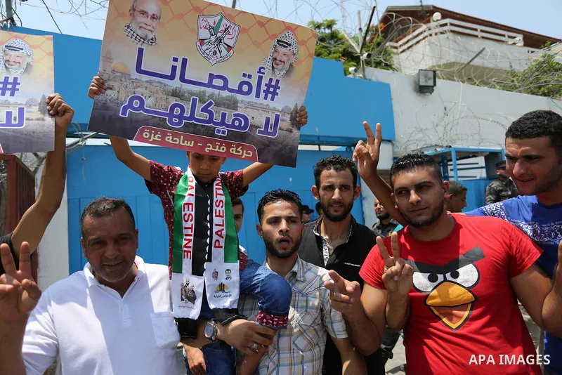 Palestinians Supporters of Fateh movement hold banners and march during a demonstration in Gaza City on July 20, 2017 against new Israeli security measures at Al-Aqsa mosque compound, which include metal detectors and ca...