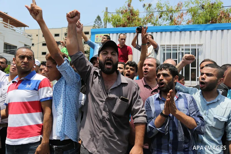 Palestinians Supporters of Fateh movement hold banners and march during a demonstration in Gaza City on July 20, 2017 against new Israeli security measures at Al-Aqsa mosque compound, which include metal detectors and ca...