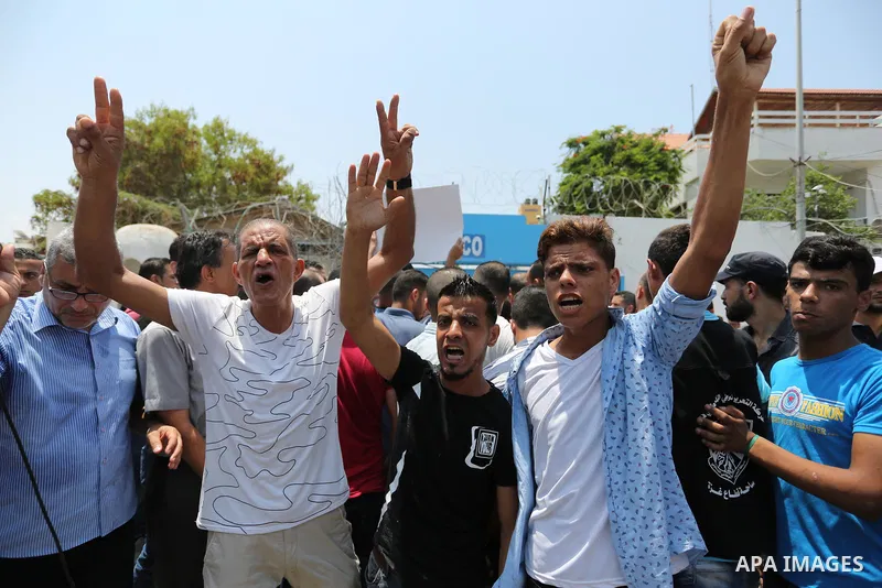 Palestinians Supporters of Fateh movement hold banners and march during a demonstration in Gaza City on July 20, 2017 against new Israeli security measures at Al-Aqsa mosque compound, which include metal detectors and ca...