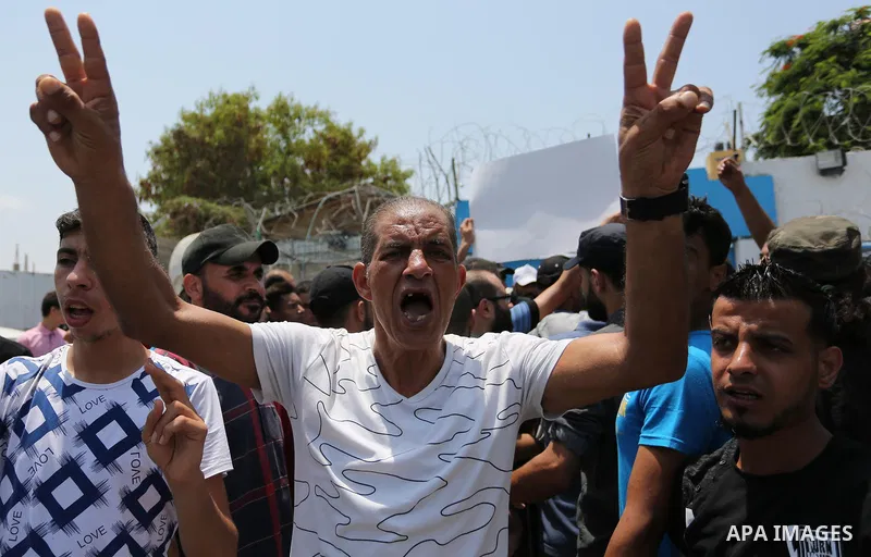 Palestinians Supporters of Fateh movement hold banners and march during a demonstration in Gaza City on July 20, 2017 against new Israeli security measures at Al-Aqsa mosque compound, which include metal detectors and ca...