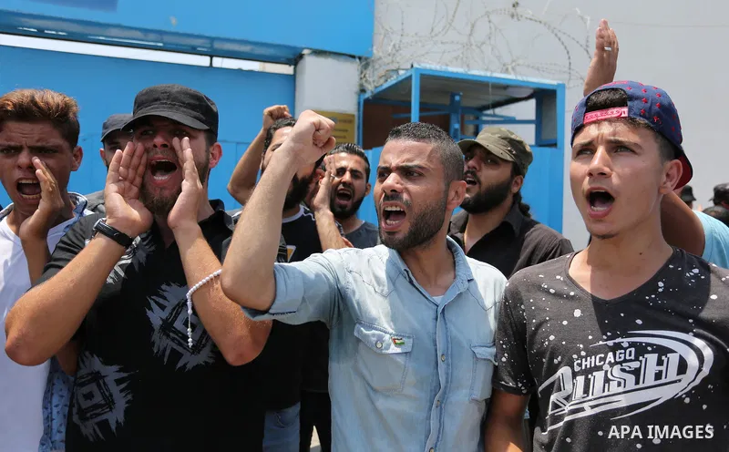 Palestinians Supporters of Fateh movement hold banners and march during a demonstration in Gaza City on July 20, 2017 against new Israeli security measures at Al-Aqsa mosque compound, which include metal detectors and ca...