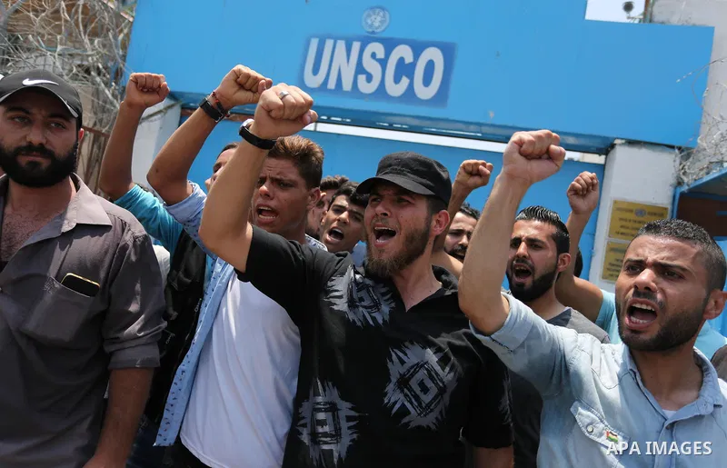 Palestinians Supporters of Fateh movement hold banners and march during a demonstration in Gaza City on July 20, 2017 against new Israeli security measures at Al-Aqsa mosque compound, which include metal detectors and ca...