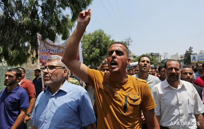 Palestinians Supporters of Fateh movement hold banners and march during a demonstration in Gaza City on July 20, 2017 against new Israeli security measures at Al-Aqsa mosque compound, which include metal detectors and ca...