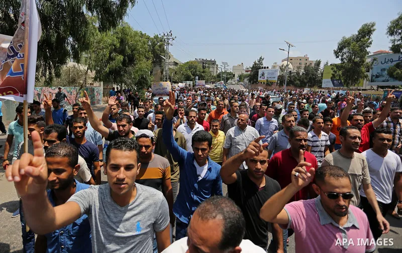 Palestinians Supporters of Fateh movement hold banners and march during a demonstration in Gaza City on July 20, 2017 against new Israeli security measures at Al-Aqsa mosque compound, which include metal detectors and ca...