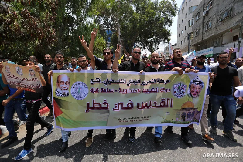 Palestinians Supporters of Fateh movement hold banners and march during a demonstration in Gaza City on July 20, 2017 against new Israeli security measures at Al-Aqsa mosque compound, which include metal detectors and ca...