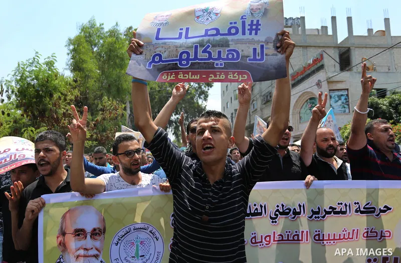 Palestinians Supporters of Fateh movement hold banners and march during a demonstration in Gaza City on July 20, 2017 against new Israeli security measures at Al-Aqsa mosque compound, which include metal detectors and ca...