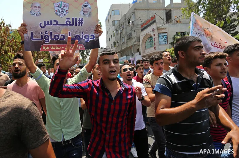 Palestinians Supporters of Fateh movement hold banners and march during a demonstration in Gaza City on July 20, 2017 against new Israeli security measures at Al-Aqsa mosque compound, which include metal detectors and ca...