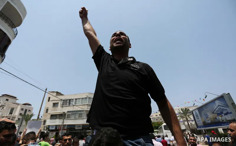 Palestinians Supporters of Fateh movement hold banners and march during a demonstration in Gaza City on July 20, 2017 against new Israeli security measures at Al-Aqsa mosque compound, which include metal detectors and ca...
