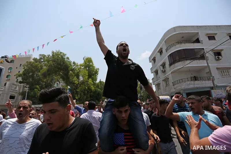Palestinians Supporters of Fateh movement hold banners and march during a demonstration in Gaza City on July 20, 2017 against new Israeli security measures at Al-Aqsa mosque compound, which include metal detectors and ca...