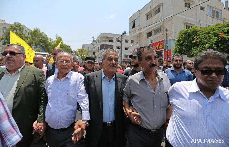 Palestinians Supporters of Fateh movement hold banners and march during a demonstration in Gaza City on July 20, 2017 against new Israeli security measures at Al-Aqsa mosque compound, which include metal detectors and ca...