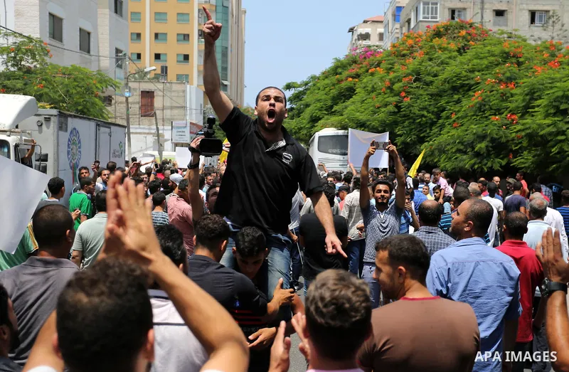 Palestinians Supporters of Fateh movement hold banners and march during a demonstration in Gaza City on July 20, 2017 against new Israeli security measures at Al-Aqsa mosque compound, which include metal detectors and ca...