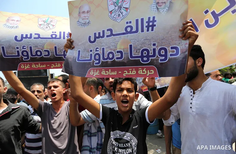Palestinians Supporters of Fateh movement hold banners and march during a demonstration in Gaza City on July 20, 2017 against new Israeli security measures at Al-Aqsa mosque compound, which include metal detectors and ca...
