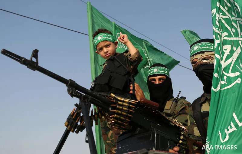 Palestinian Hamas militants take part in a military show against Israel's newly-installed security measures at the entrance to the al-Aqsa mosque compound, in Khan Younis, in the southern Gaza Strip July 20, 2017. Photo...