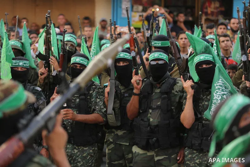 Palestinian Hamas militants take part in a military show against Israel's newly-installed security measures at the entrance to the al-Aqsa mosque compound, in Khan Younis, in the southern Gaza Strip July 20, 2017. Photo...