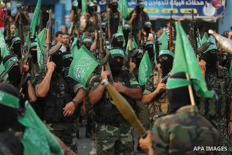 Palestinian Hamas militants take part in a military show against Israel's newly-installed security measures at the entrance to the al-Aqsa mosque compound, in Khan Younis, in the southern Gaza Strip July 20, 2017. Photo...
