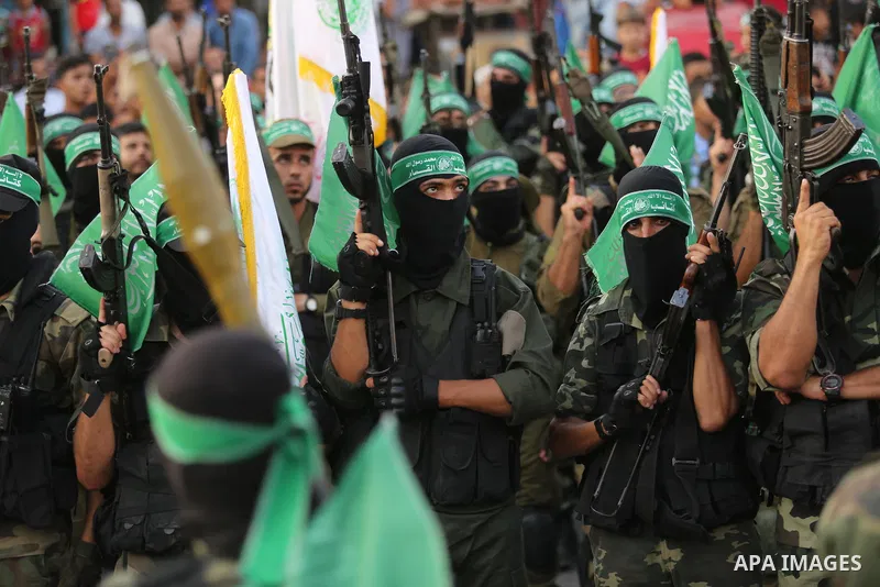Palestinian Hamas militants take part in a military show against Israel's newly-installed security measures at the entrance to the al-Aqsa mosque compound, in Khan Younis, in the southern Gaza Strip July 20, 2017. Photo...
