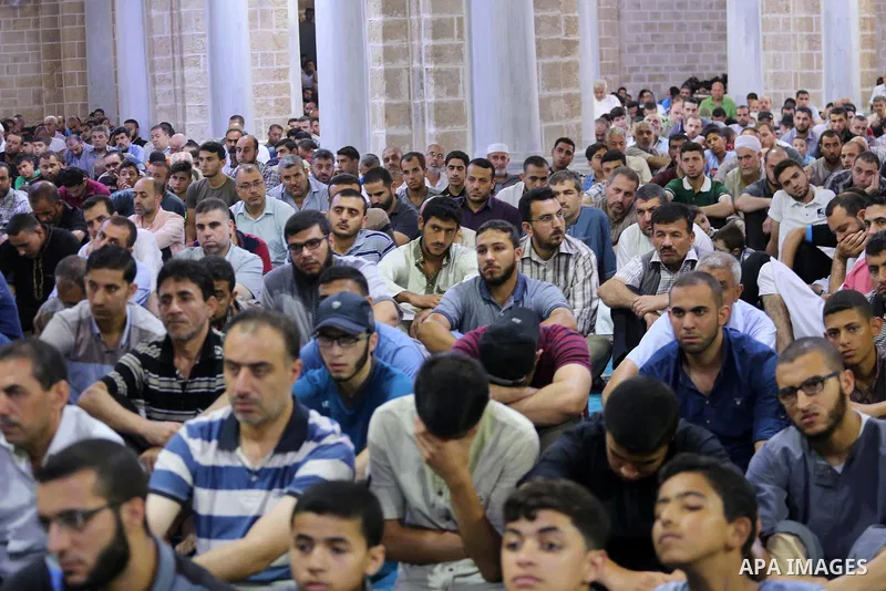 Palestinian Muslims attend Friday prayer at the al-Omari mosque in Gaza city on July 21, 2017. Photo by Mohammed Asad