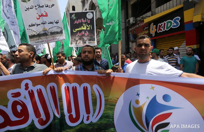 Palestinians take part during a protest against Israel's newly-installed security measures at the entrance to the al-Aqsa mosque compound in Gaza city on July 21, 2017. Photo by Mohammed Asad