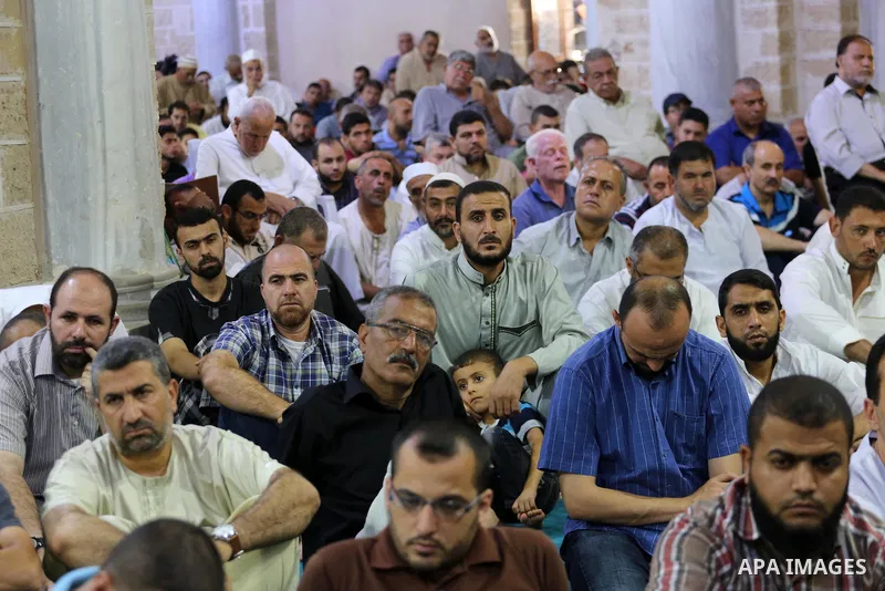 Palestinian Muslims attend Friday prayer at the al-Omari mosque in Gaza city on July 21, 2017. Photo by Mohammed Asad