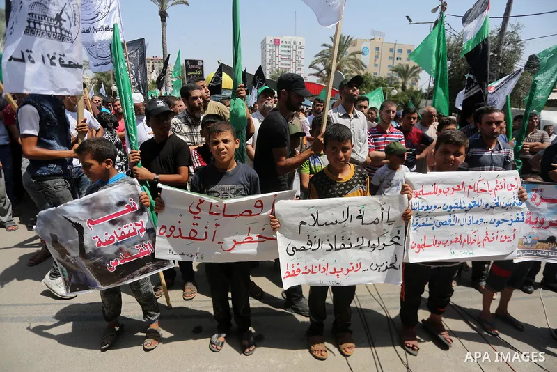 Palestinian demonstrators take part during a protest against Israel's new security measures at the entrance to the al-Aqsa mosque compound, which include metal detectors and cameras, in Gaza City on July 21, 2017. Photo...