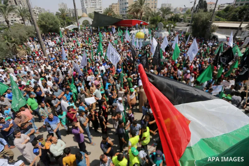 Palestinian demonstrators carry a model of the Dome of the Rock mosque during a protest against Israel's new security measures at the entrance to the al-Aqsa mosque compound, which include metal detectors and cameras, in...