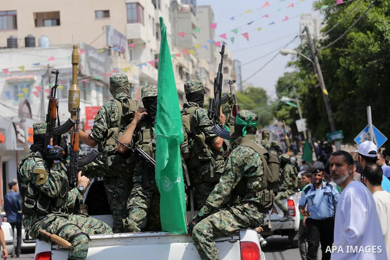Palestinian Hamas militants take part in a protest against Israel's new security measures at the entrance to the al-Aqsa mosque compound, which include metal detectors and cameras, in Gaza City on July 21, 2017. Photo by...