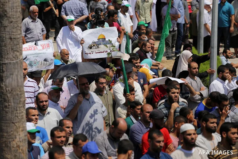 Palestinian demonstrators take part during a protest against Israel's new security measures at the entrance to the al-Aqsa mosque compound, which include metal detectors and cameras, in Gaza City on July 21, 2017. Photo...