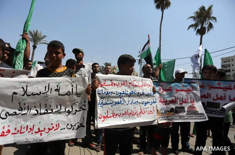 Palestinian demonstrators take part during a protest against Israel's new security measures at the entrance to the al-Aqsa mosque compound, which include metal detectors and cameras, in Gaza City on July 21, 2017. Photo...