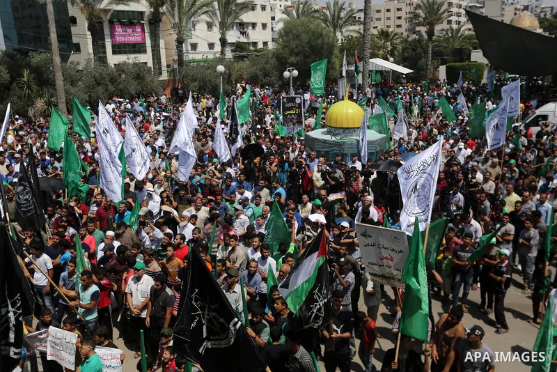 Palestinian demonstrators carry a model of the Dome of the Rock mosque during a protest against Israel's new security measures at the entrance to the al-Aqsa mosque compound, which include metal detectors and cameras, in...