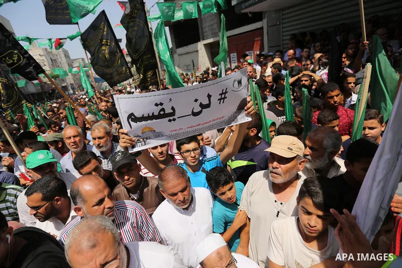 Palestinian demonstrators take part in a protest against Israel's new security measures at the entrance to the al-Aqsa mosque compound, which include metal detectors and cameras, in Khan Younis in the the southern Gaza s...