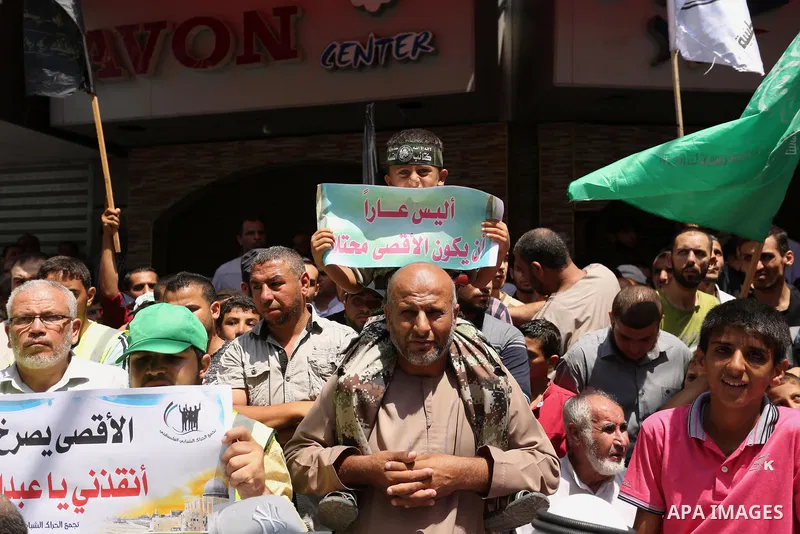 Palestinian demonstrators take part in a protest against Israel's new security measures at the entrance to the al-Aqsa mosque compound, which include metal detectors and cameras, in Khan Younis in the the southern Gaza s...