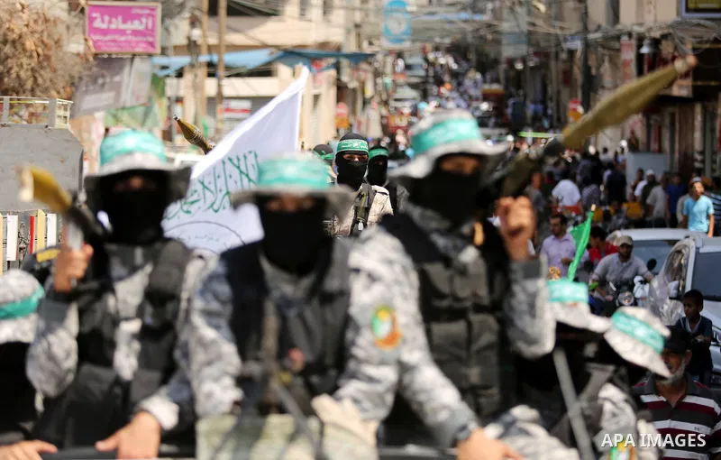 Palestinian Hamas militants take part in a protest against Israel's new security measures at the entrance to the al-Aqsa mosque compound, which include metal detectors and cameras, in Khan Younis in the the southern Gaza...