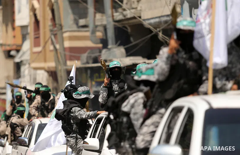 Palestinian Hamas militants take part in a protest against Israel's new security measures at the entrance to the al-Aqsa mosque compound, which include metal detectors and cameras, in Khan Younis in the the southern Gaza...
