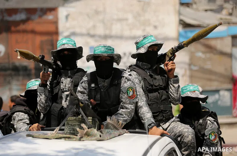 Palestinian Hamas militants take part in a protest against Israel's new security measures at the entrance to the al-Aqsa mosque compound, which include metal detectors and cameras, in Khan Younis in the the southern Gaza...