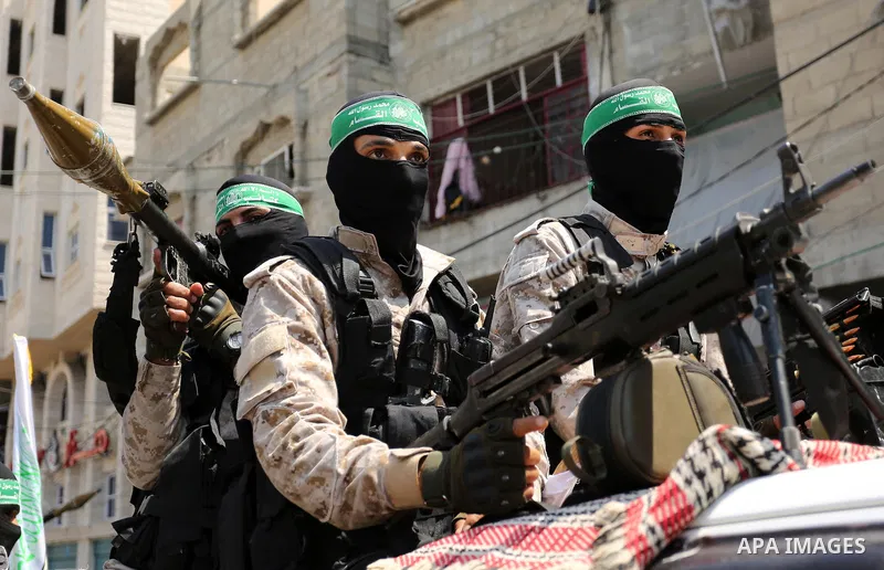 Palestinian Hamas militants take part in a protest against Israel's new security measures at the entrance to the al-Aqsa mosque compound, which include metal detectors and cameras, in Khan Younis in the the southern Gaza...