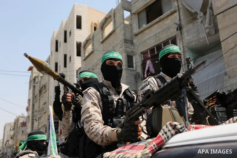 Palestinian Hamas militants take part in a protest against Israel's new security measures at the entrance to the al-Aqsa mosque compound, which include metal detectors and cameras, in Khan Younis in the the southern Gaza...