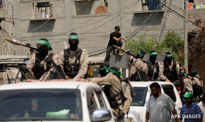 Palestinian Hamas militants take part in a protest against Israel's new security measures at the entrance to the al-Aqsa mosque compound, which include metal detectors and cameras, in Khan Younis in the the southern Gaza...
