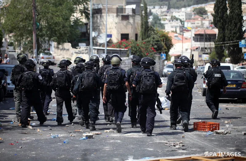 Israeli security forces take position during clashes with Palestinian protesters following Friday prayer outside Jerusalem's Old City on July 21, 2017, after Israeli police barred men under 50 from entering the Old City...