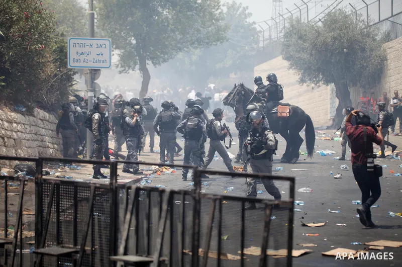 Israeli security forces take position during clashes with Palestinian protesters following Friday prayer outside Jerusalem's Old City on July 21, 2017, after Israeli police barred men under 50 from entering the Old City...