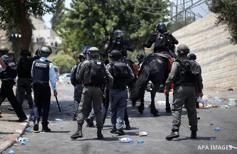 Israeli security forces take position during clashes with Palestinian protesters following Friday prayer outside Jerusalem's Old City on July 21, 2017, after Israeli police barred men under 50 from entering the Old City...