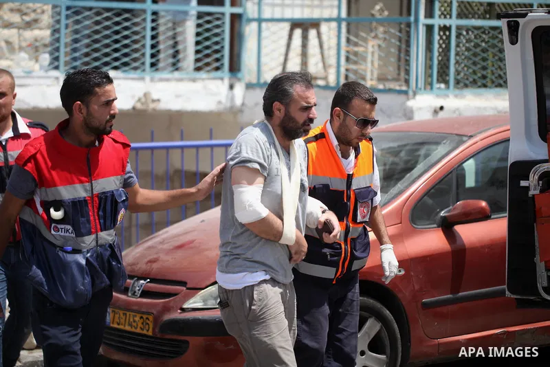 Palestinians evacute a wounded man during clashes with Israeli security forces following Friday prayer outside Jerusalem's Old City on July 21, 2017, after Israeli police barred men under 50 from entering the Old City fo...