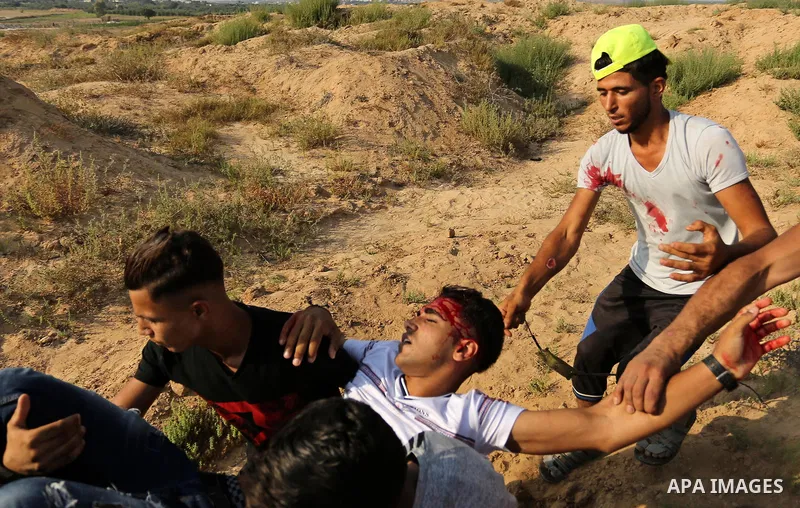 A wounded Palestinian protester is evacuated during clashes with Israeli security forces near the border between Israel and central Gaza Strip in a protest against Israel's new security measures at the entrance to the al...