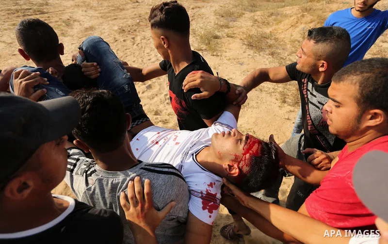 A wounded Palestinian protester is evacuated during clashes with Israeli security forces near the border between Israel and central Gaza Strip in a protest against Israel's new security measures at the entrance to the al...