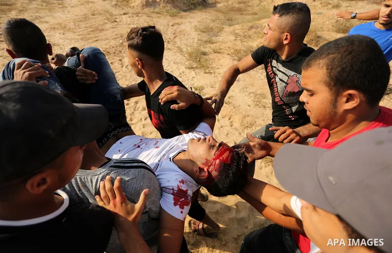 A wounded Palestinian protester is evacuated during clashes with Israeli security forces near the border between Israel and central Gaza Strip in a protest against Israel's new security measures at the entrance to the al...