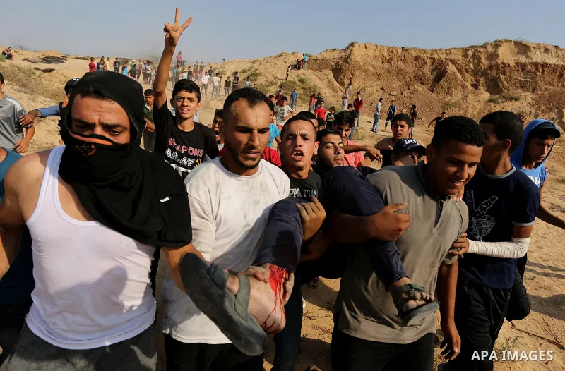 A wounded Palestinian protester is evacuated during clashes with Israeli security forces near the border between Israel and central Gaza Strip in a protest against Israel's new security measures at the entrance to the al...