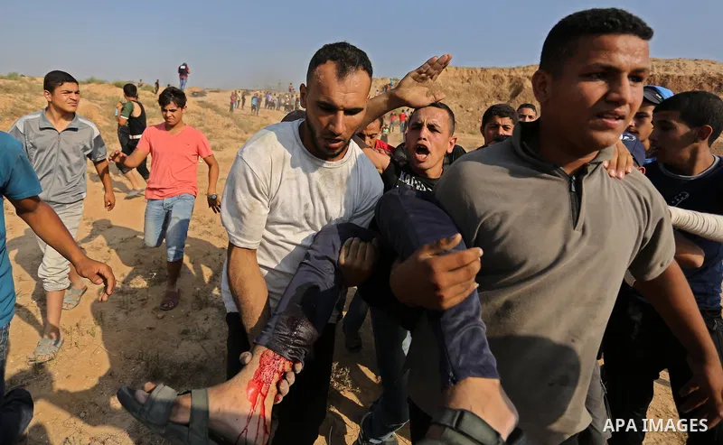 A wounded Palestinian protester is evacuated during clashes with Israeli security forces near the border between Israel and central Gaza Strip in a protest against Israel's new security measures at the entrance to the al...