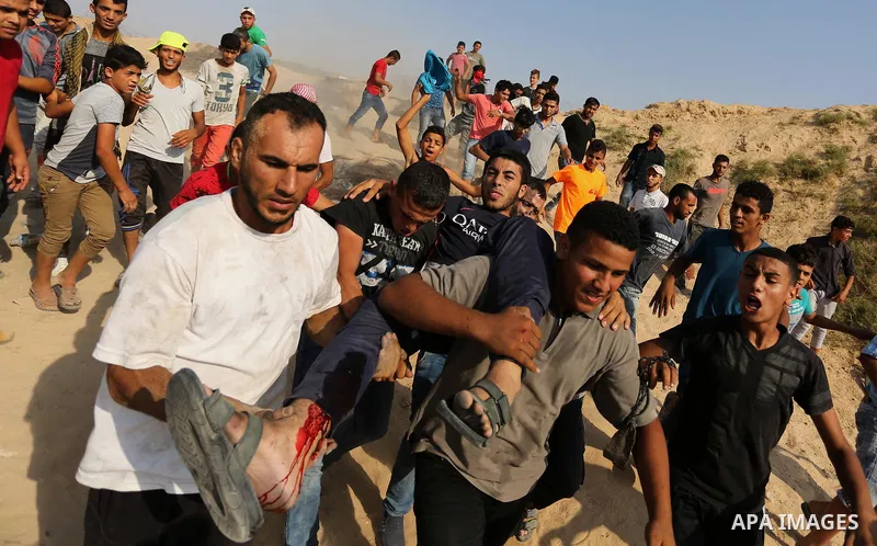 A wounded Palestinian protester is evacuated during clashes with Israeli security forces near the border between Israel and central Gaza Strip in a protest against Israel's new security measures at the entrance to the al...
