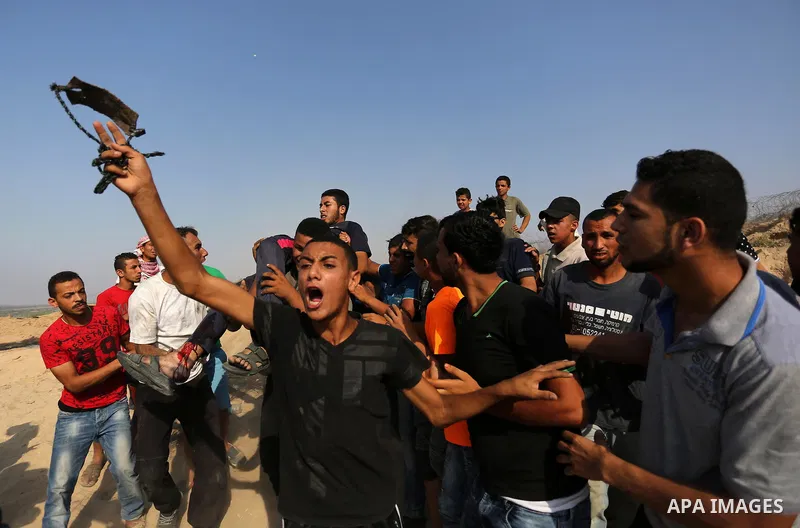 A wounded Palestinian protester is evacuated during clashes with Israeli security forces near the border between Israel and central Gaza Strip in a protest against Israel's new security measures at the entrance to the al...