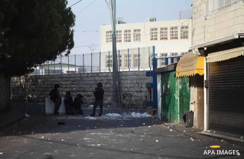 Israeli security forces take position during clashes with Palestinian protesters following Friday prayer outside Jerusalem's Old City on July 21, 2017, after Israeli police barred men under 50 from entering the Old City...